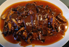 Dish with babi pangang and sauce ready to serve